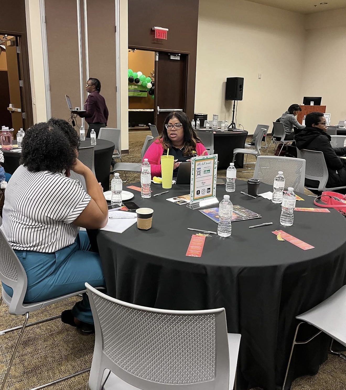Dominque Burgess in conversation with education leaders at a roundtable event