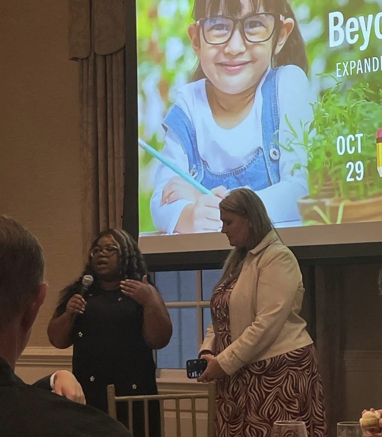 Dominque Burgess presenting alongside a colleague at an education innovation event